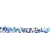 Blue star festive border with a myriad of small stars scattered along the bottom of the frame isolated on white with copy space