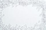 Glistening water droplets frame on white with a random arrangement of clean clear water round water drops surrounding central copy space