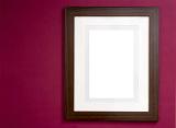 Photo or painting frame in smooth glossy finish with blank area for copy space or image over dark red wall