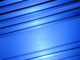Close up on blue metal or wood panel as cool high tech abstract background with copy space