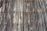 Over head view background of dried and aged bamboo tethered together into mats