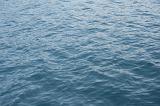 Full frame background texture of the water surface of a calm ocean with ripples