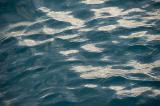 Full frame top down view of slightly wavy and steady water for background with copy space