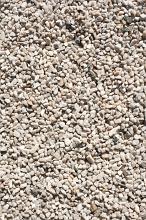 Simple white and gray chipped stone, gravel or kitty litter on an even level with copy space