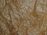 Single layer of simple wrinkled brown wrapping paper as abstract background with copy space