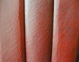 Abstract background composed of three cracked red leather book spines