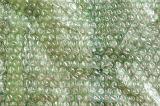 Simple green small plastic bubble wrap packaging textured background with copy space