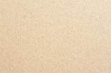 Close up of light brown background with cardboard or coarse recycled fibrous texture with copy space