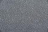 Gray crackled false leather background pattern with small dark seams and copy space