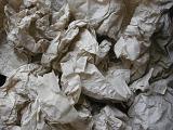 Background texture of crumpled packing paper used to wad and protect items in transit in a full frame overhead view