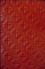 Red metal full background with cross shape pattern inside beveled corner squares with copy space