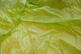 Creased and wrinkled light green tissue paper sheets with copy space close up