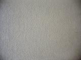 Top down close up view of worn out neutral color carpet fabric or wallpaper backdrop in random rows as abstract textured background