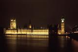 Houses of Parliament and Big Ben, London, illuminated at night and reflected in the water of the River Thames below
