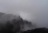 rugged mountainous landscape with mist or low cloud in the yellow mountains, china