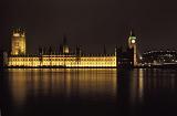 Palace of Westminster, the Houses of Parliament and Big Ben on the bank of the River Thames, London, illuminated at night and reflected in the river below