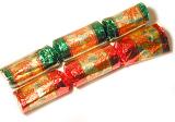High Angle View of Two Christmas Crackers on White Background, One Wrapped in Red Foil and the Other in Green Foil Paper Printed with Poinsettias