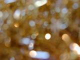 Out of focus close up of shiny gold tinsel