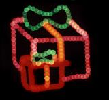 christmas lights in the shape of some colorful parcels with a ribbon bow