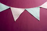 Triangular pink and blue bunting on a red background forming an upper border with copy space below