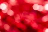 Sparkling hexagonal red party bokeh background with copy space for a festive event or greeting card in a full frame texture