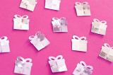 Silver Birthday Confetti Shaped Like Wrapped Presents Scattered on Hot Pink Background