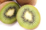 Fresh halved kiwifruit showing the texture of the pulp and pattern of the pips, on white