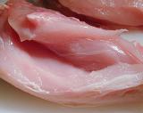 Texture of raw lean chicken meat with a close up view of a fillet with the skin removed ready for cooking