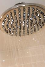 water droplets running from a large shower head