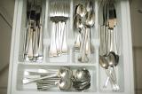 Open cutlery drawer with an inside divided tray for neat storage of silver metal knives, forks, spoons and teaspoons