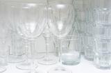 Wine and water glasses on a shelf in a white cupboard