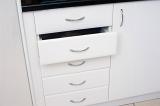 Set of white kitchen drawers in a built in cabinet unit with one drawer slightly open