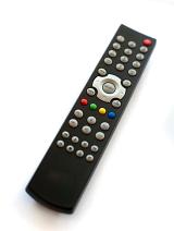 Infrared or wireless remote control for a television lying at an oblique angle on a white background