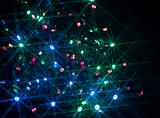 a background of red green and blue festive lights with a starburst effect
