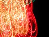 overlapping tangled swirls of orange and red light