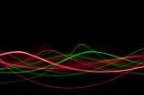 a visualisation of sound waveforms formed from sinusoidal trails of light