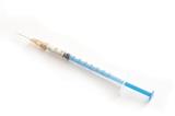 High Angle View of Syringe Filled with Injectable Medication Angled on White Background