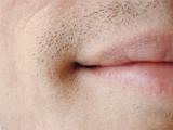 Extreme Close Up of Male Mouth Smirking and Moustache Stubble Above Lip