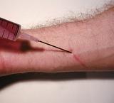 Detail of Man Injecting Medication or Drugs into Veins in Fore Arm with Large Gauge Needle