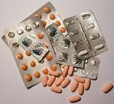 High Angle View of Assortment of Pills and Tablets in Foil Blister Packets Arranged on Plain Background
