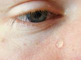 Extreme Close Up of Tear Drop Falling from Crying Eye, Person Looking Sad and Crying with Tear Drop on Cheek