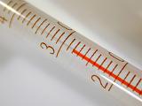 Close Up of Celcius Alcohol Thermometer with Low Temperature Reading Below Normal Body Temperature on White Background