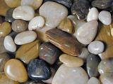 Background texture of assorted colorful natural pebbles or stones worn smooth by the tumbling action of the water of the sea or a river