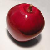 A decorative red ceramic apple on light background