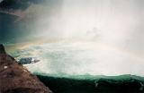 Rainbow in the cloud of fine spray and mist over Niagara Falls with turbulent white water below