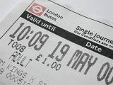 London bus ticket for single journey for adult with valid date and time printed, viewed in close-up on white background. Public transportation concept