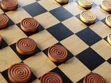 wooden pieces set up on a checkers game board