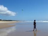 flying a kite on the beach