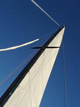 laying on the deck of a sailing yacht looking up at the sky