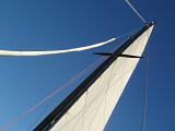 laying back and looking up at the mast as you sail along on a yacht